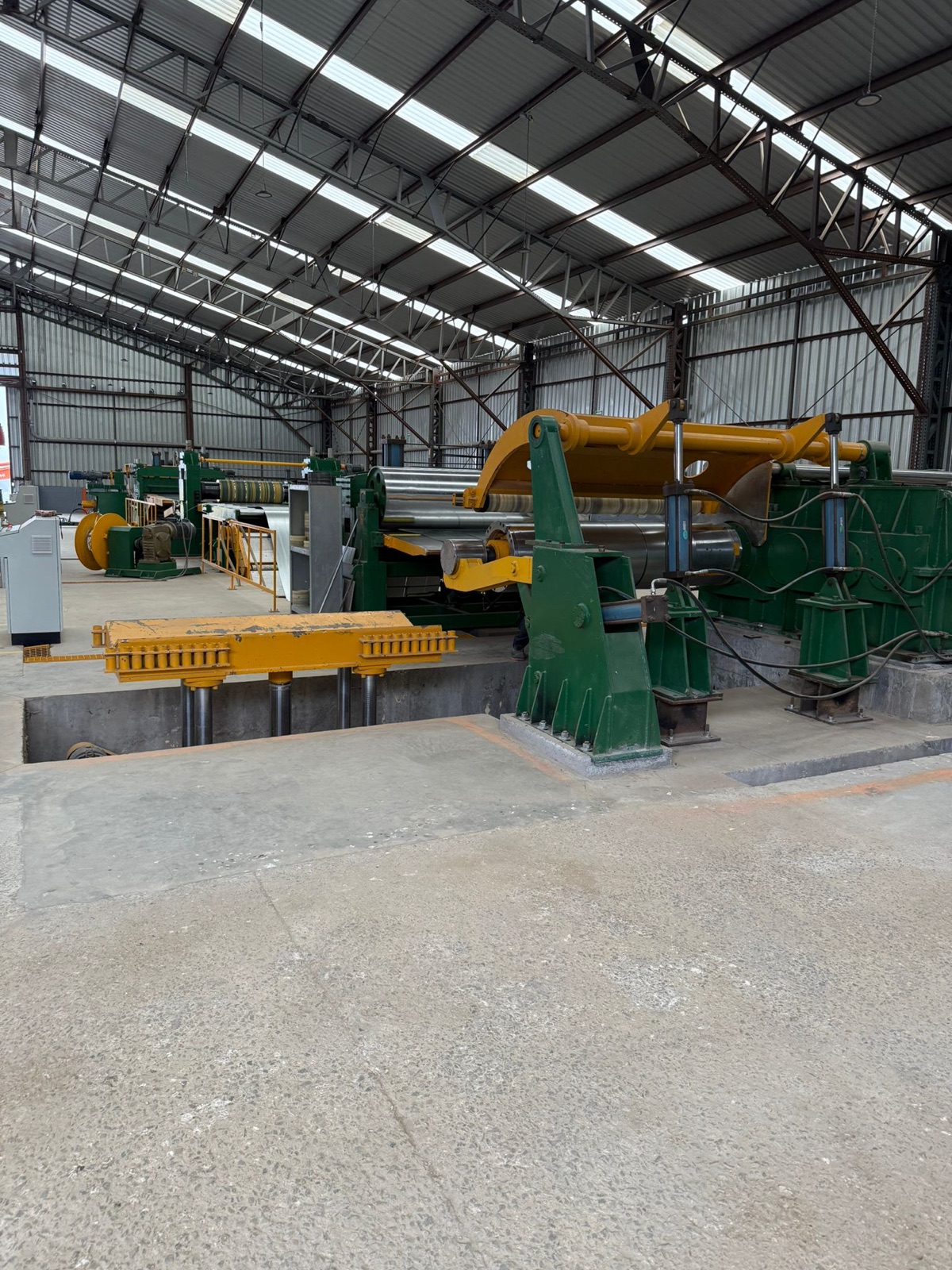 Master steel coils and the slitting line on the Cal Steel production floor.